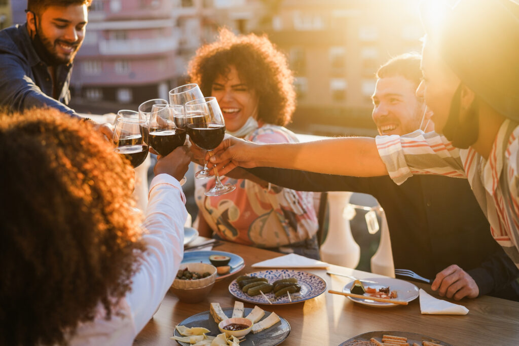 friends enjoying wine on the balcony for feature image